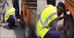 Traffic warden helps elderly rickshaw driver change his tyre
