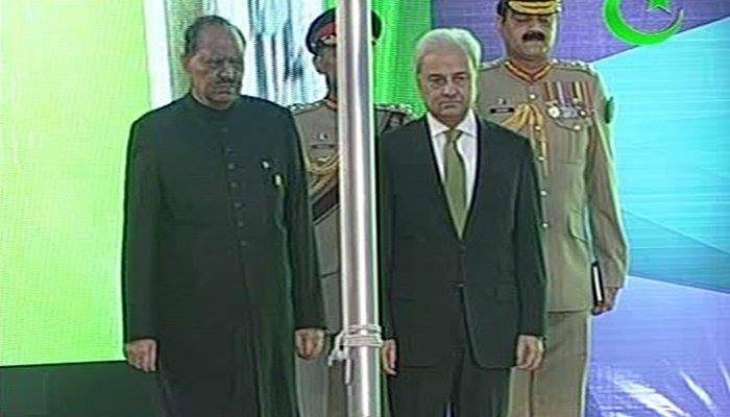 الرئيس ممنون حسين ورئيس الوزراء الانتقالي ناصر الملك يرفعان العلم الباكستاني احتفالا بالعيد الوطني