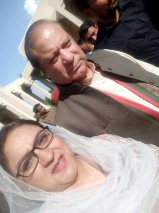 Nawaz Sharif presents flower to female party member outside court 