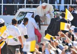 Pope Francis greets crowds as young girl rushes to hand him letter at Sheikh Zayed Stadium