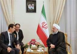 الرئیس السوري بشار الأسد یلتقي نظیرہ الایراني حسن روحاني في العاصمة الایرانیة طھران