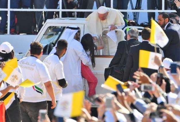 Pope Francis greets crowds as young girl rushes to hand him letter at Sheikh Zayed Stadium