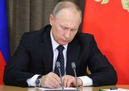Russian President Vladimir Putin signs a decree 