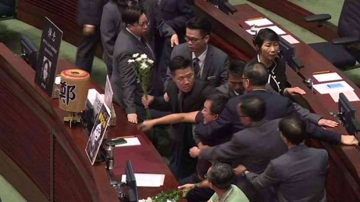 Hong Kong: Hecklers dragged out in new parliament chaos