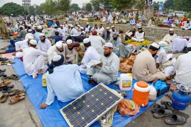 JUI-F workers carry solar panels, batteries to charge cell phones