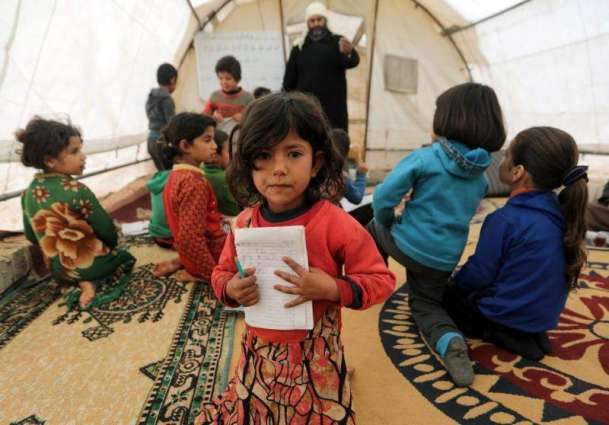 Having fled bombing, Syrian children learn to read in tent schools