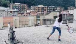 Girls play rooftop tennis in Italian city