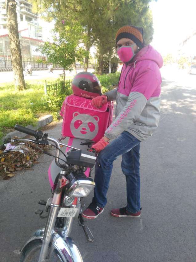 foodpanda rider with mask and gloves on field