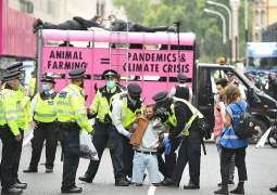 Bare-Chested Extinction Rebellion Women Activists Lock Themselves to UK Parliament Gates