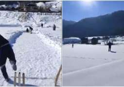 Boys enjoy playing cricket amid heavy snowfall in IIOJ&K
