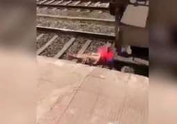 Video showing woman lying on track with train passing over her goes viral