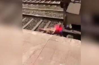 Video showing woman lying on track with train passing over her goes viral