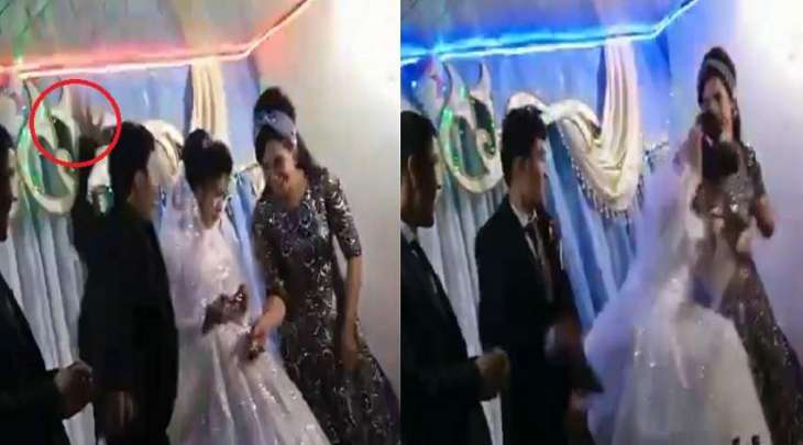 شاھد مقطع : عریس فی أوزبکستان یصفع عروسہ بقوة علی رأسھا خلال حفل زفافھما