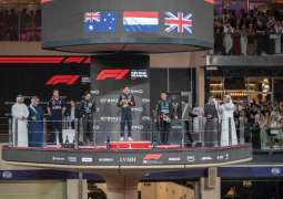 Theyab bin Zayed presents trophy to 17th Formula 1 Etihad Airways Abu Dhabi Grand Prix winner Lando Norris